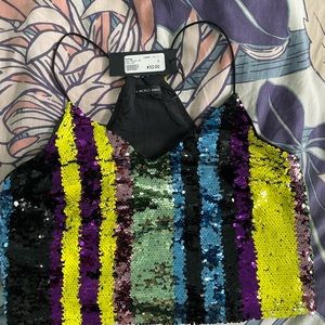 A World Away top with multicolored sparkles, never worn, in a size small.